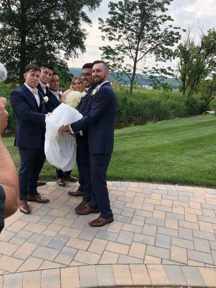 Groomsmen carrying the Bride