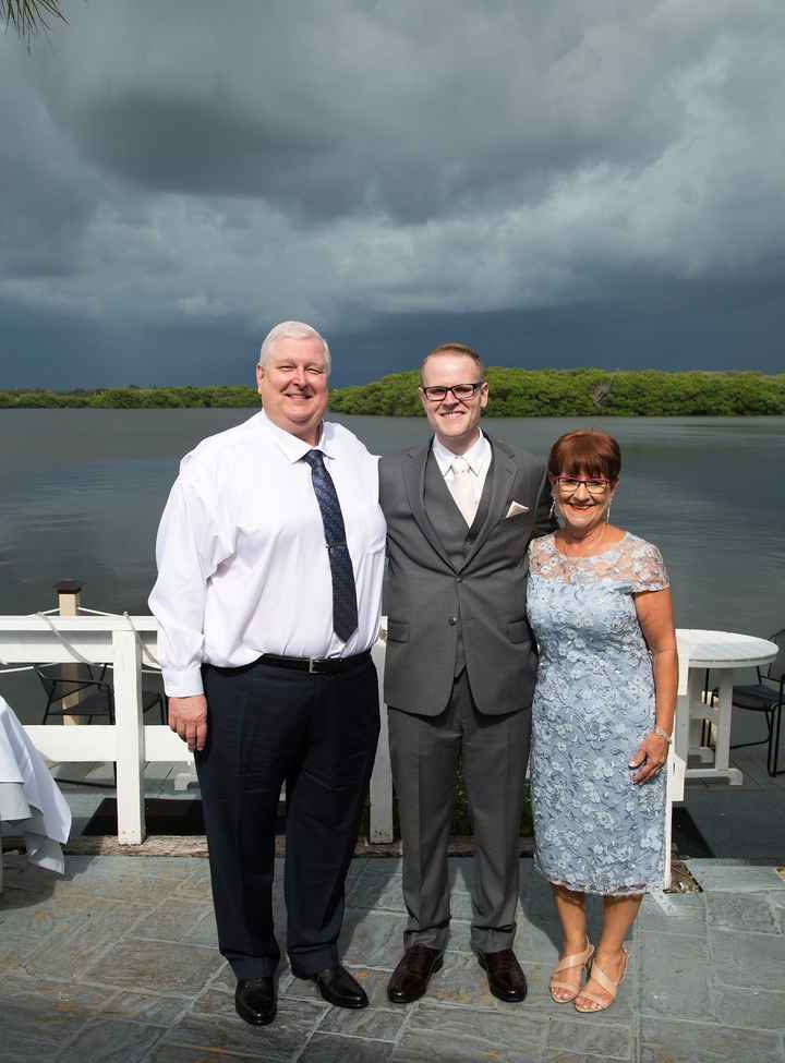 My husband and his parents before the ceremony. Look at those clouds!