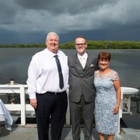 My husband and his parents before the ceremony. Look at those clouds!