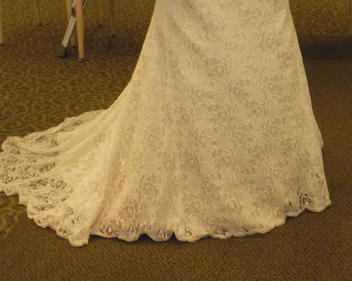 Bought a dress that had been worn once- lace overlay is shorter than the dress