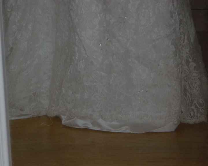 Bought a dress that had been worn once- lace overlay is shorter than the dress