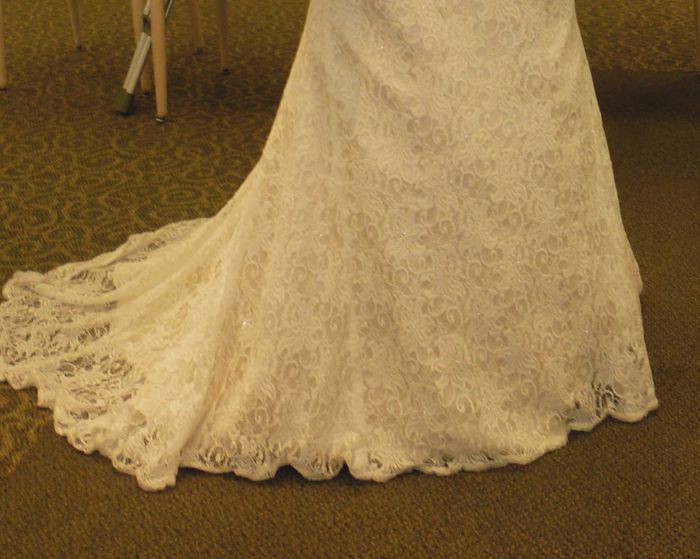 Bought a dress that had been worn once- lace overlay is shorter than the dress
