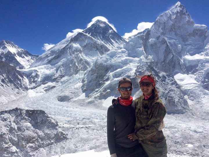 At the summit of Kala Patthar- Mount Everest is the peak to the left of us with cloud around it