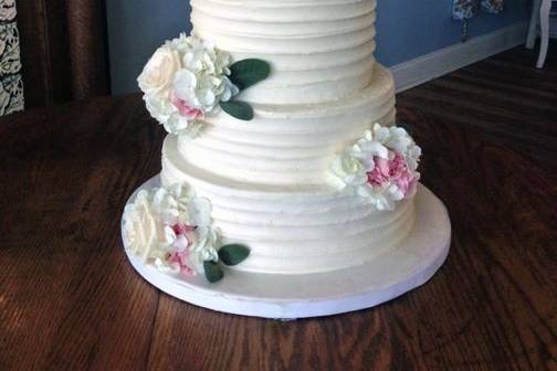 A rustic buttercream cake with fresh florals.