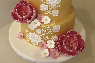 Sugar peonies and hand piped lotus flowers adorned this Thai inspired cake with sculpted sugar elephants.