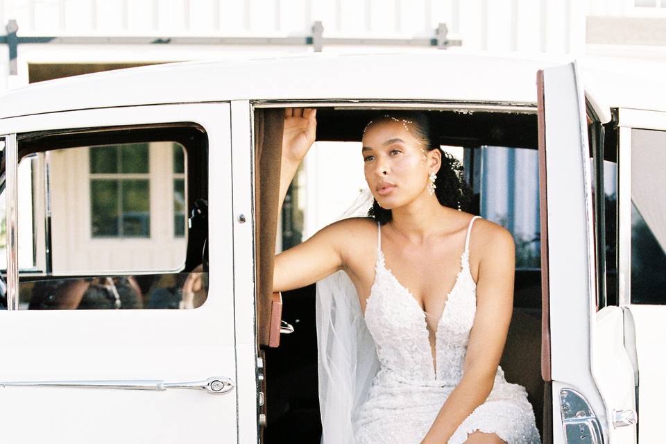 Bride sitting in vintage car
