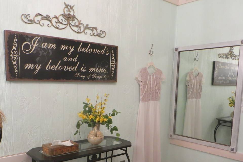 Bridal room has a simple, romantic feel. Two vanities, bridal mirror, futon couch, and adjoining full bath.