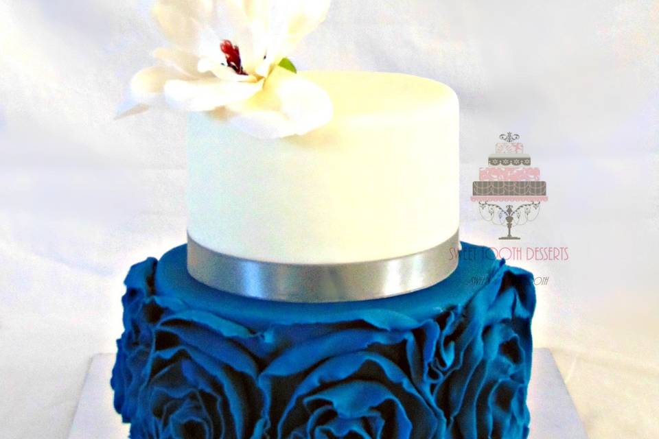 2 Tier (8in and 6in) White and Teal Blue Ruffled Wedding cake with a faux single White Lily for the topper.