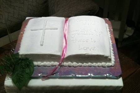 Bible shaped - I Cor. 13:13, ...and the greatest of these is love.Hidden beneath all that white icing is a German Chocolate Cake complete with coconut/pecan filling. YUMMY!