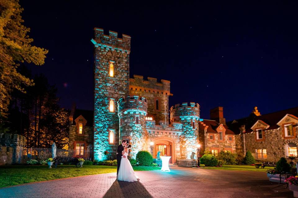 Couple embrace before castle venue