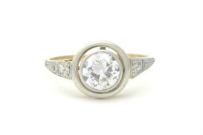 Art Deco 14k yellow and white gold engagement ring with an old European cut diamond center and a single cut diamond accent in each shoulder.