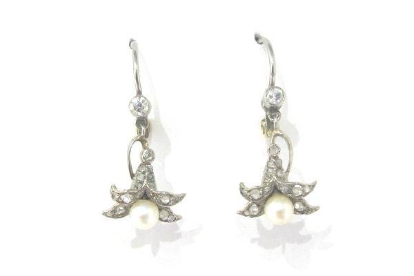 Antique Art Nouveau earrings with pearl and diamonds. A sterling silver lily is studded with rose cut diamonds, with a lever back closure.
