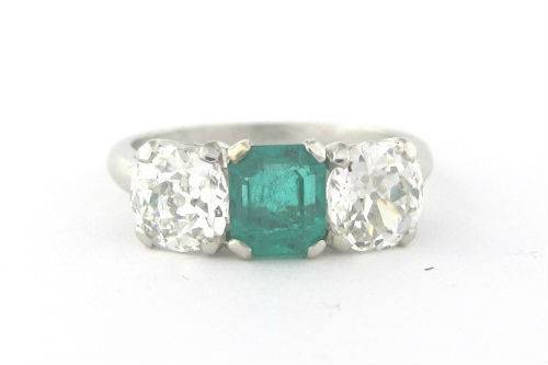 Vintage Art Deco diamond and emerald engagement ring in platinum.