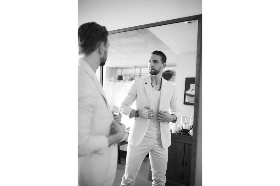 Groom getting ready in mirror