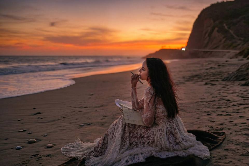 Bride writing vows on beach