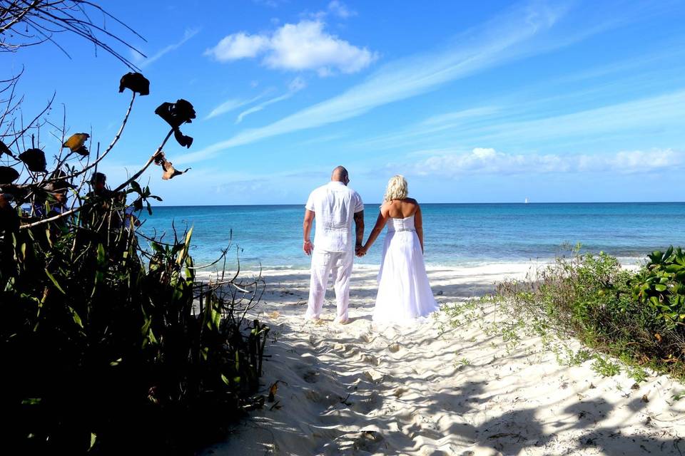 Couple looking out at Nuptial Beach Nassau Bahamas just after their beach wedding ceremony