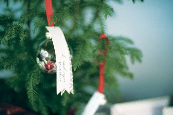 Mix of Letterpress, and Screen Printing. Glitter, Satin, Metallic and Felt Details.Escort Cards hanging on a pine tree.