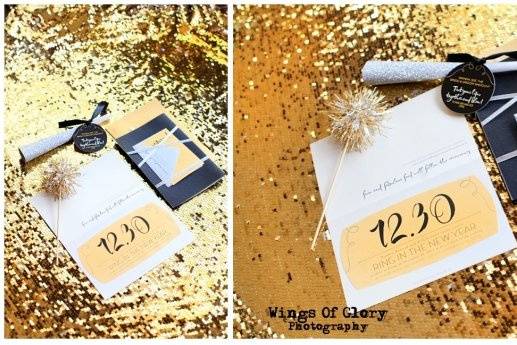 Old Hollywood Glamour New Year's Eve Wedding. Black Linen accented with gold glitter, Die Cut Glitter Numbers and words on various pieces, Silver, Gold and Champagne  Metallic Paper, Sparklers, Noise Makers and Raffle Tickets. Quotes from Old Hollywood movies adorned various signage, tags, etc. Invitations Round 2-- After the mailing, When the bride underestimated her guest list, and we were out of die cut glitter dates, we were able to make a version 2, without the glitter die cut date to save the day!