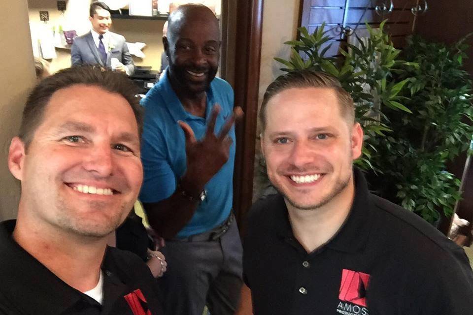 Jody Amos and Matt McCarter catching a shot with Jerry Rice