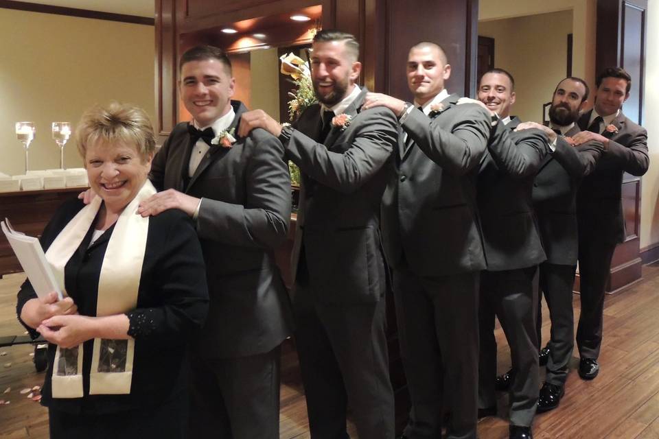 Groom and groomsmen with the officiant