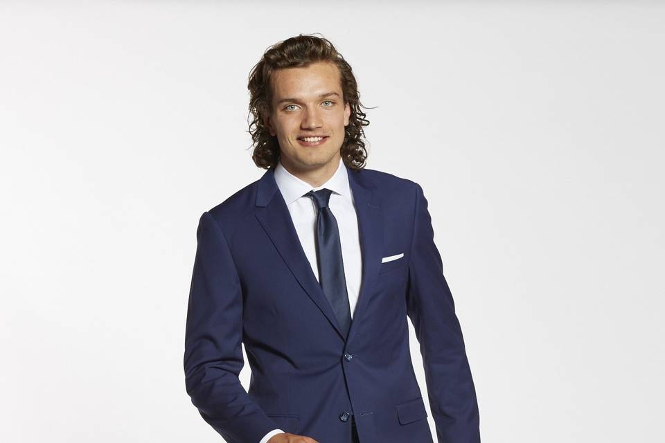 Brilliant blue groomsman suit with black shoes and navy tie