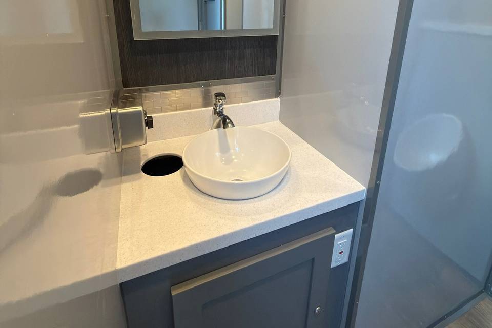 Modern sink and backlit mirror