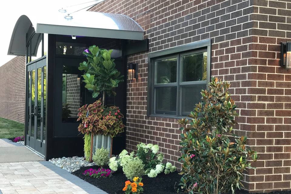 Pretty flowers, planters and welcoming magnolia tree