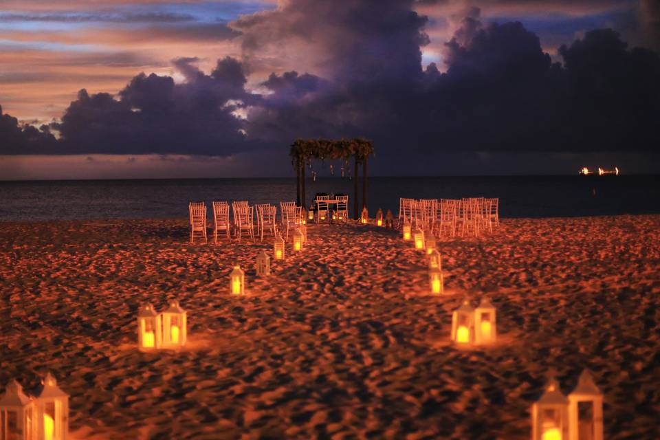 Candlelit beach wedding aisle