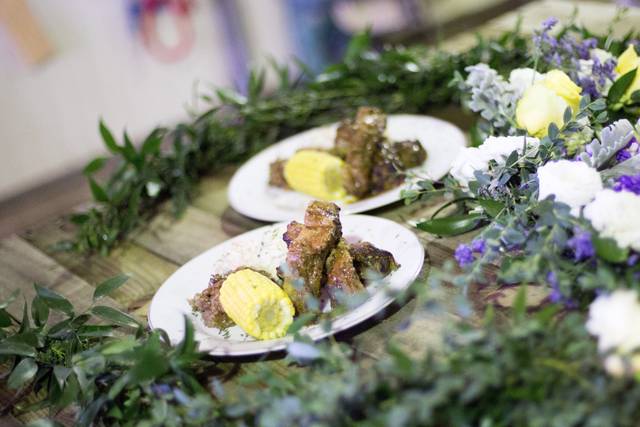 Smoked ribs with mashed potatoes, baked beans, and corn.