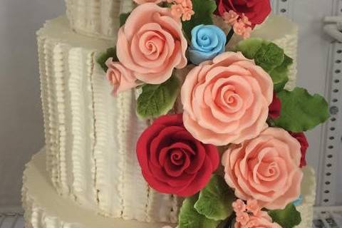 Beige cake with pink and red ascending roses