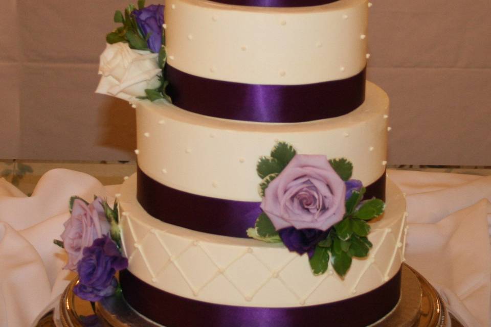 White cake with purple ribbons