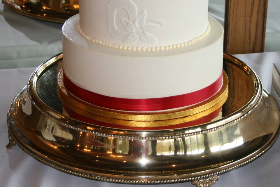 White cake with red ribbons