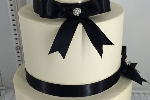White cake with black ribbons