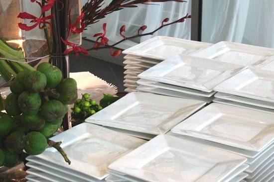 Square white hors d'oeuvres plates on the buffet