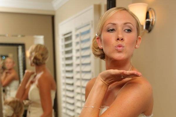 Bride and flower girl throw kisses