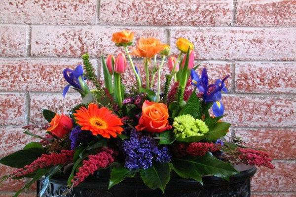 Mixed flower centerpiece, gerberas, mini green hydrangea, dutch tulips, roses, iris, heather, rununculus