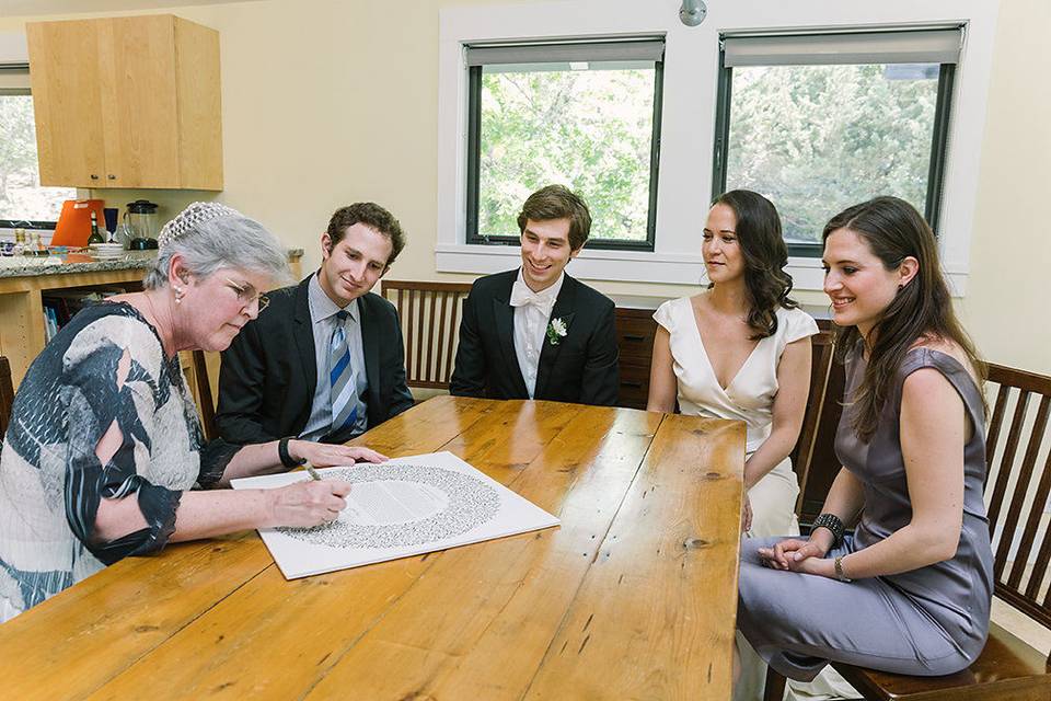 Emily and Zach signing the ketubah June 2017