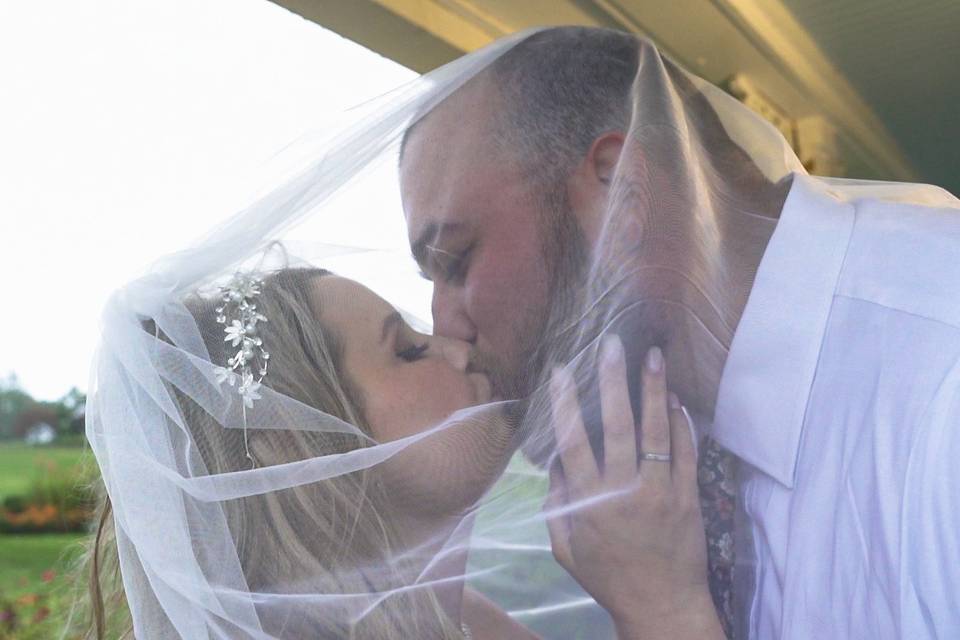 Wedding couple kiss under veil