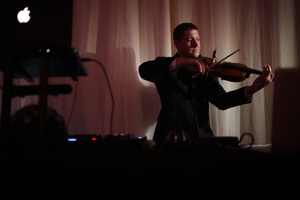 Playing the violin at the DJ booth