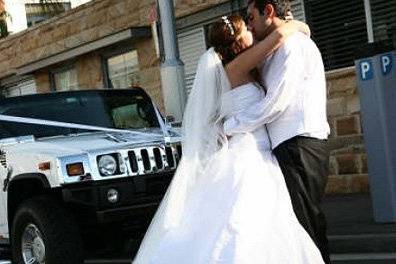 Newlyweds by the stretch Hummer