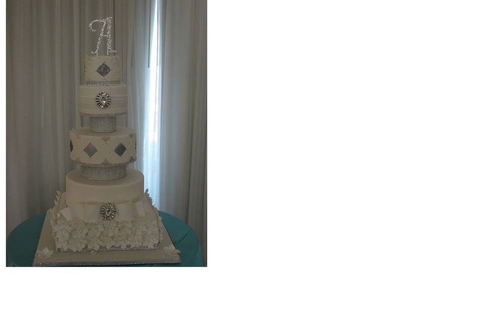 5 tier white and platinum floating wedding cake with floral base