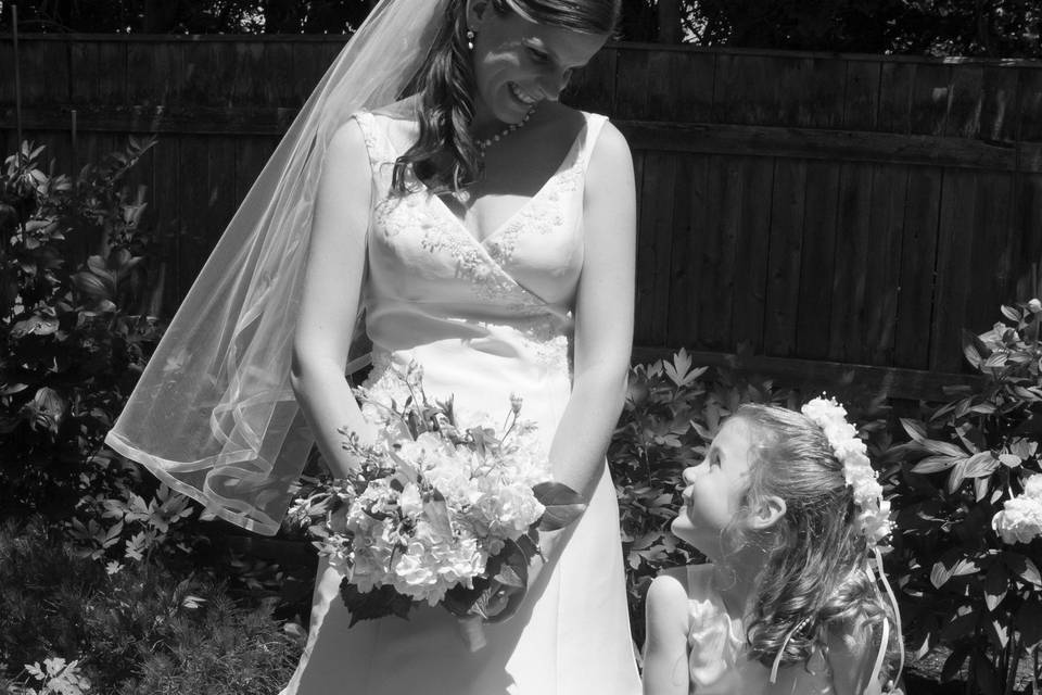 Bride with Flower Girl in mom's back yard before the wedding