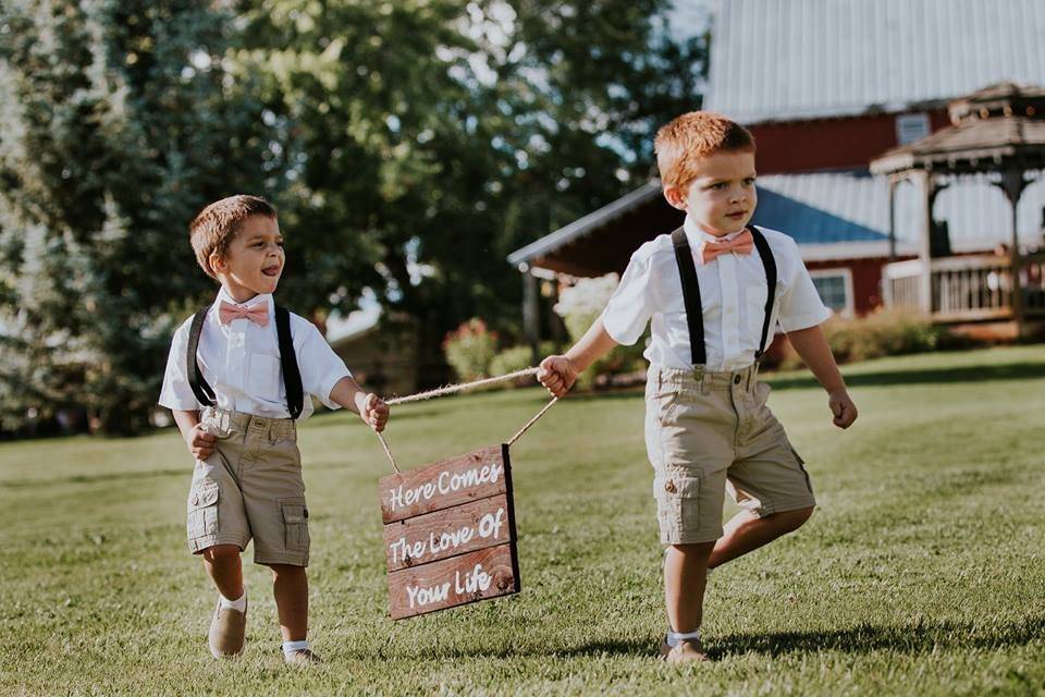 Kids carrying wedding sign board