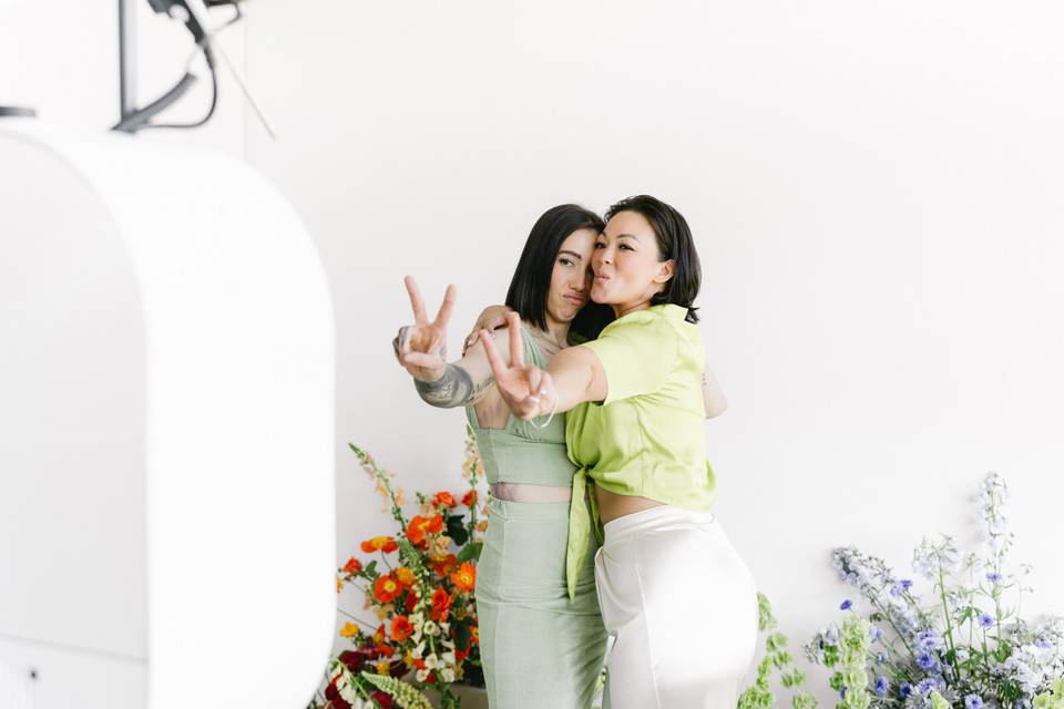 Two women posing in the booth