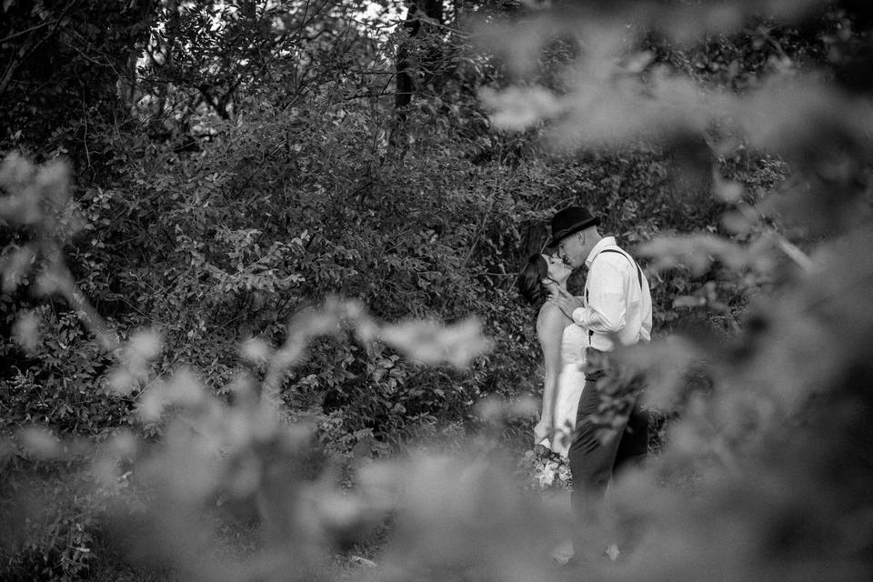 Couple kiss in the woods