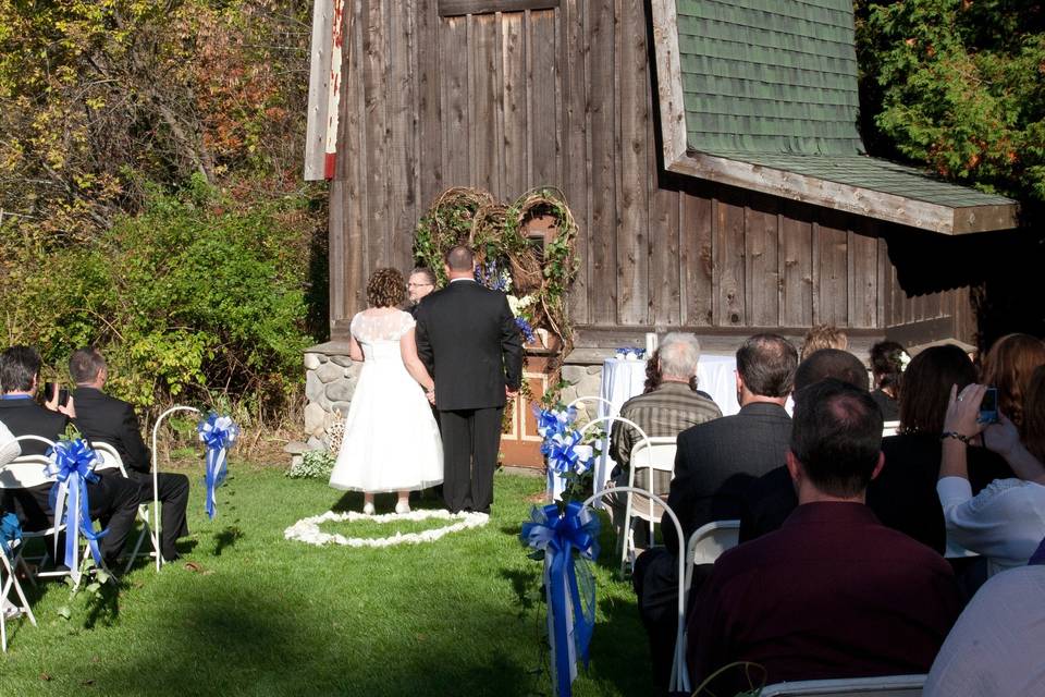 An outdoor setting in front of his Aunts barn.  A beautiful lakeside setting and a warm family oriented ceremony.
