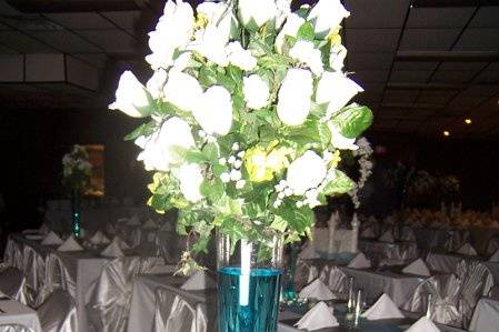 Large pilsner vase, with white ball arrangment, blue water was added along with fish for this beach theme wedding. The vase can be filled with any color water.