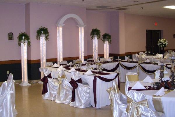 Lighted columns behind head table.