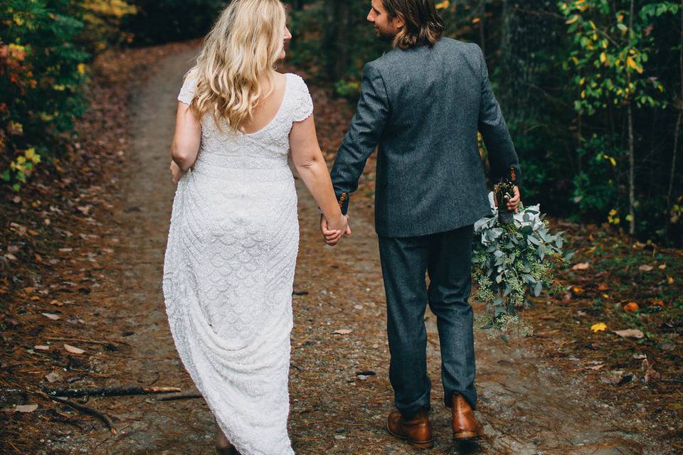 Hand holding in the woods