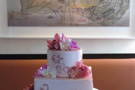 Dusty Rose buttercream icing with pink buttercream details and fresh orchids